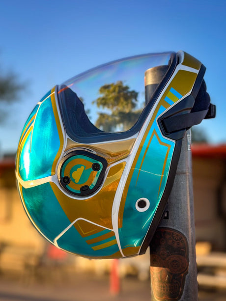 Cookie C45 skydiving helmet in a turquoise and gold custom finish outdoors